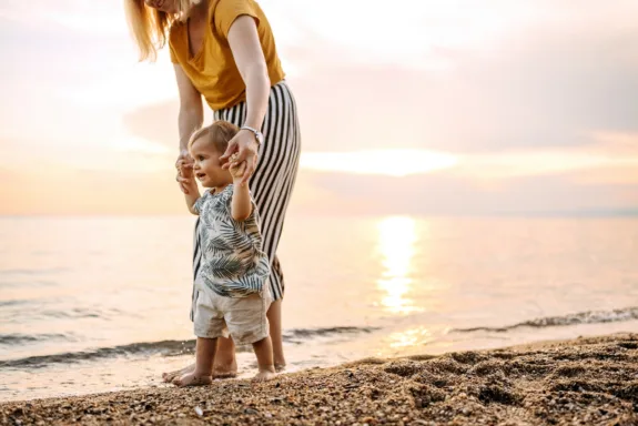 Mother and child walking on beach