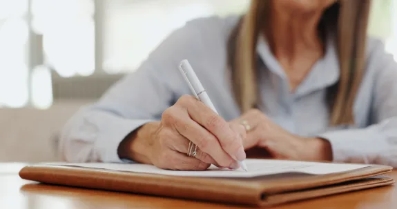 Woman signing paperwork
